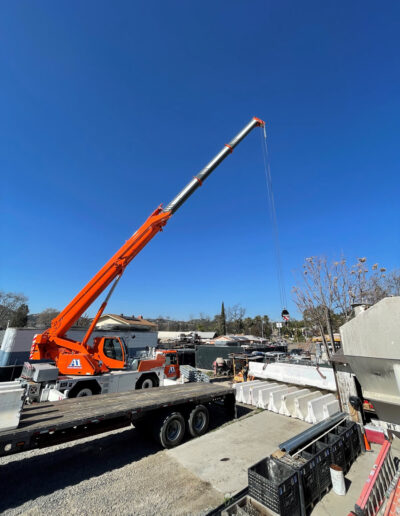 Crane lifts concrete Barriers